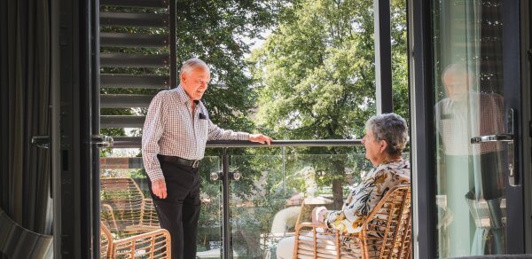Maura and David enjoying time on their walk-out balcony in the sunshine