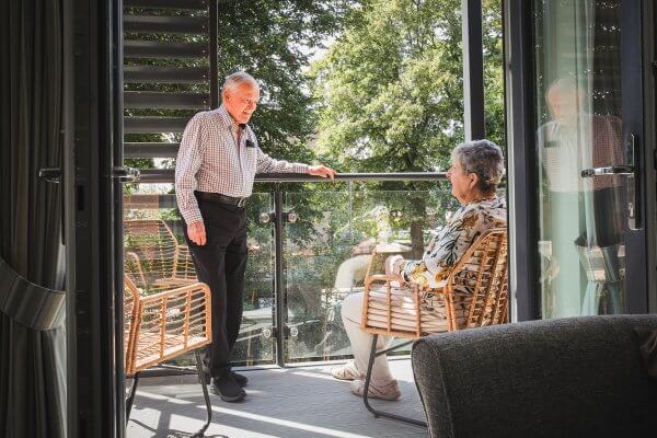 Homeowners Maura and David enjoying their balcony in the sun