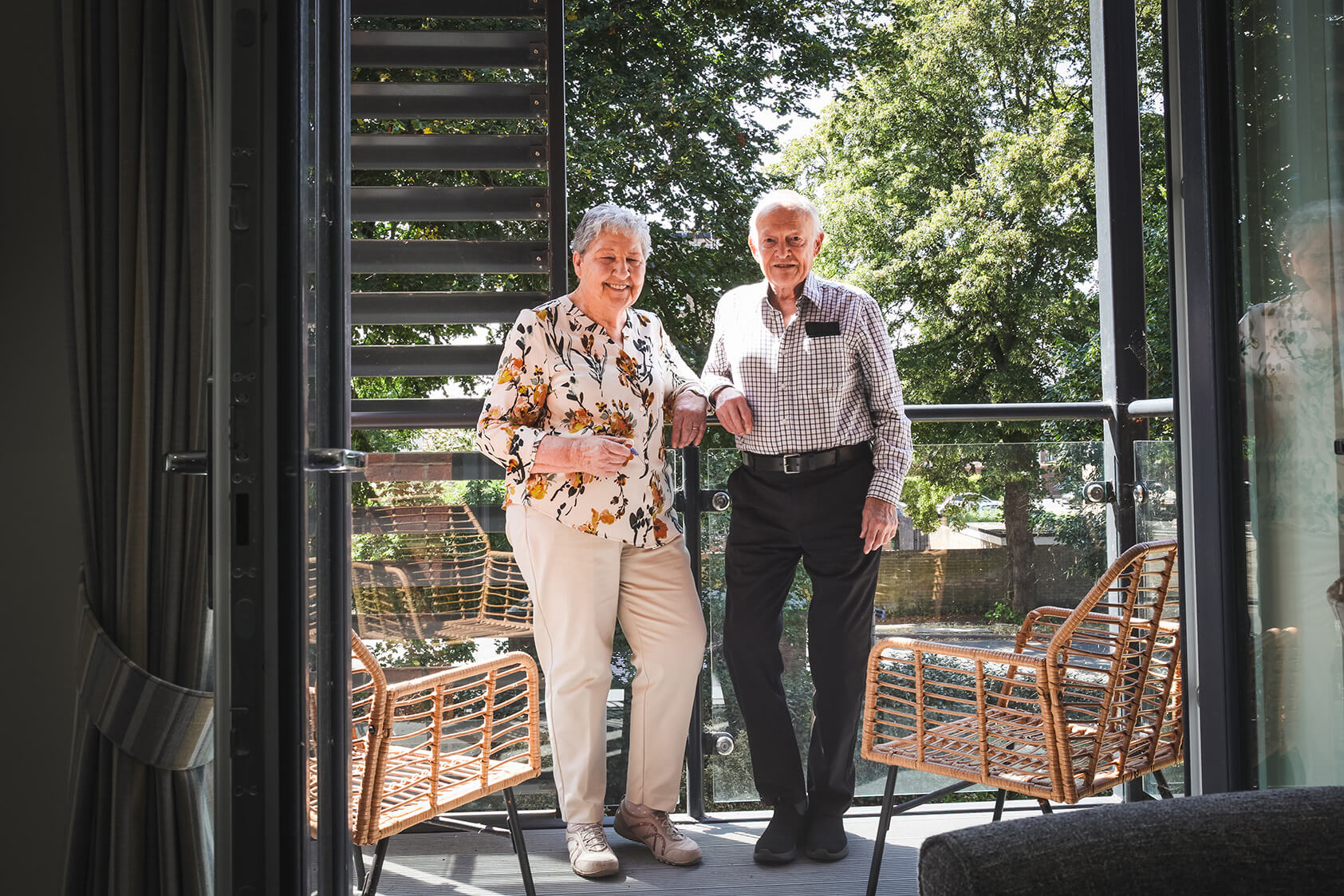 Maura and David stood on their balcony