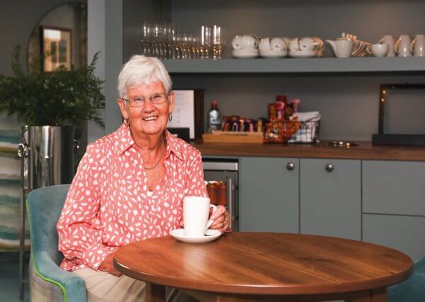 Homeowner Margaret enjoying a coffee