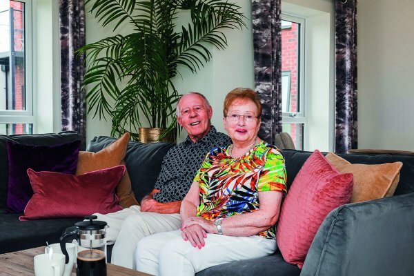 Gloria and Pete relaxing in their spacious apartment with fresh coffee