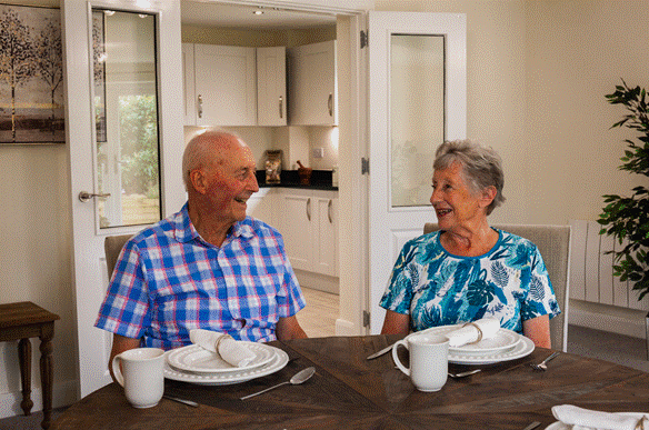 Homeowners Margaret and Keith sitting in an Adlington Retirement living apartment