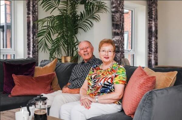 Gloria and Peter sitting in an Adlington apartment