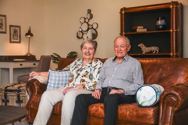 Maura and David sat on a sofa