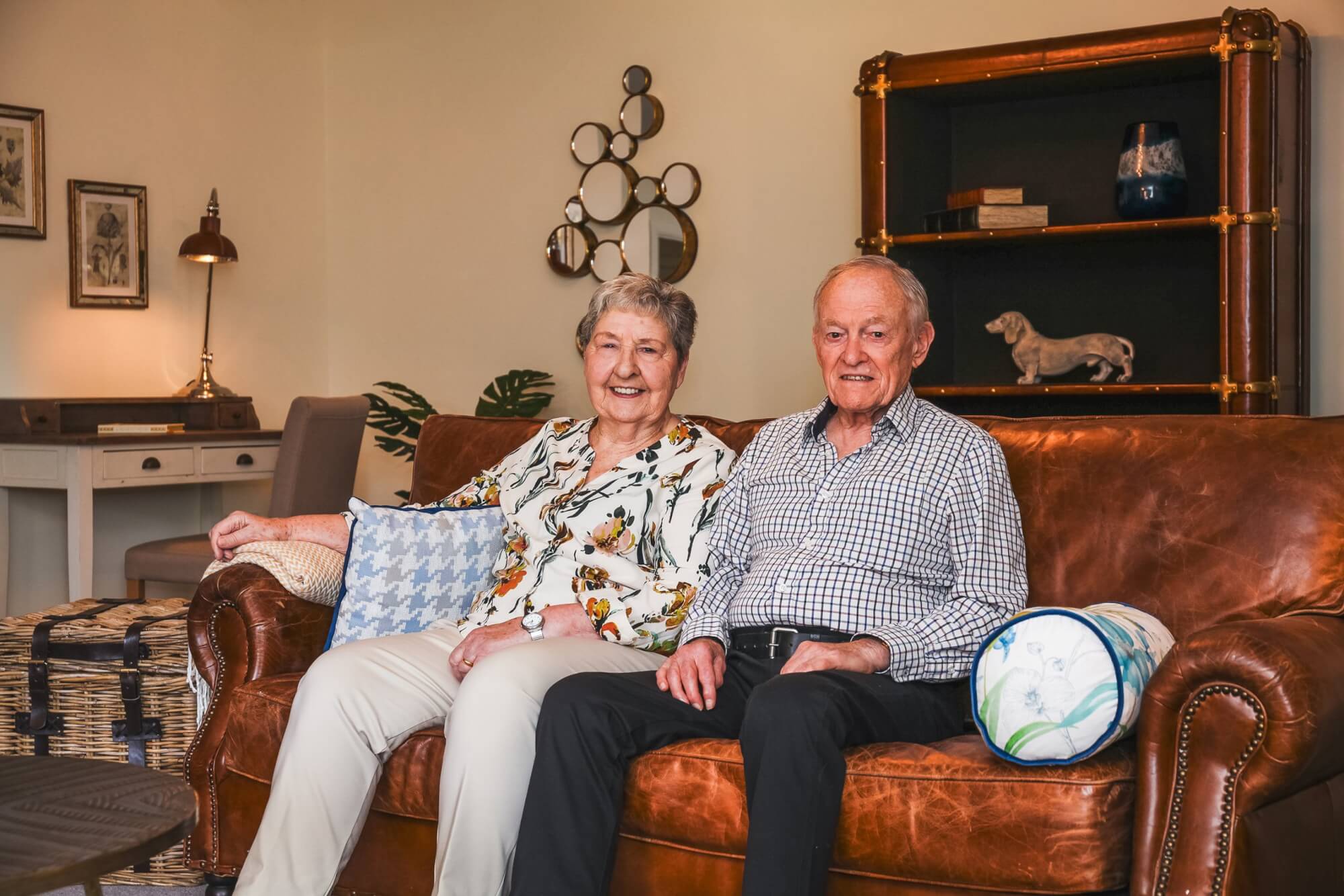 Maura and David sat on a sofa